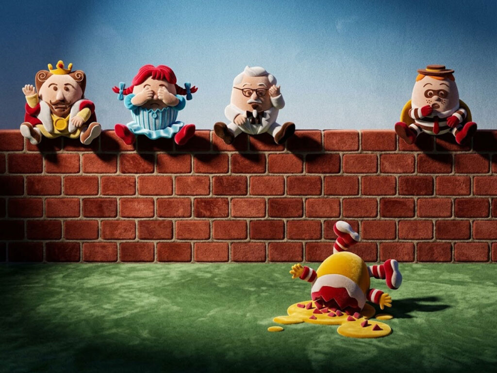 A Great Fall illustration: fast food mascots as Humpty Dumpty falling off a brick wall
